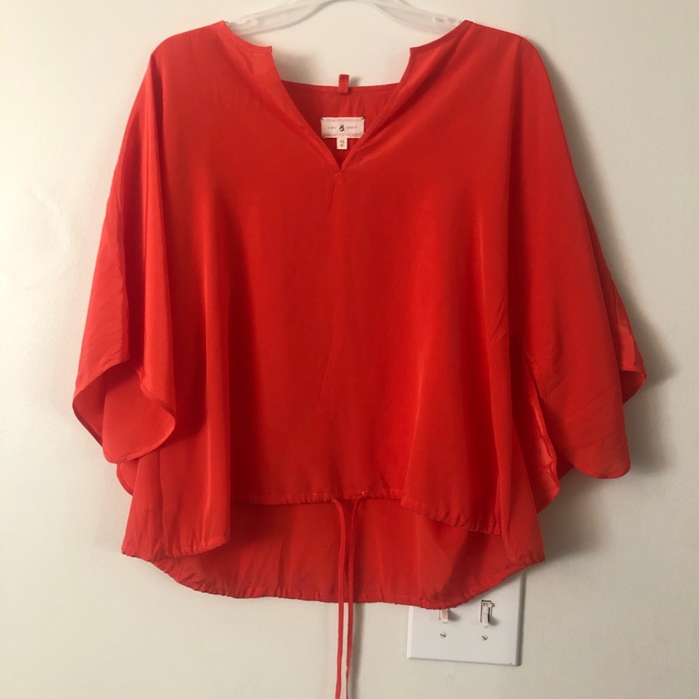 Lou and Grey-orange bell sleeve shirt with bottom tie.